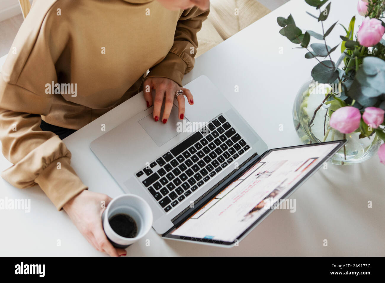 Womans hand using laptop Stock Photo - Alamy