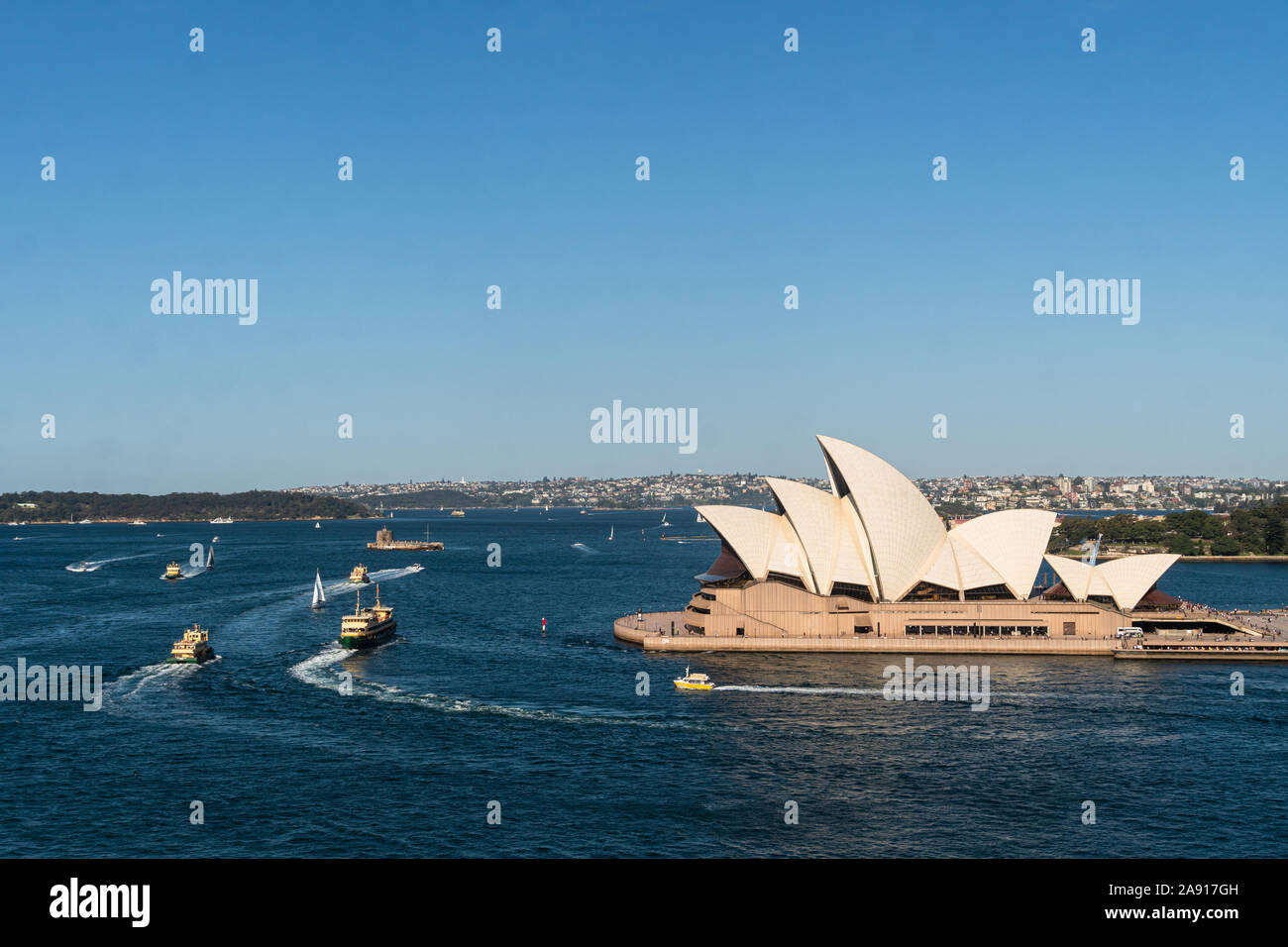 Sydney, Australia - October 3 2019: Various ferry boats sail around the Sydney harbor with the famous Opera House and the fort Denison in Australia la Stock Photo