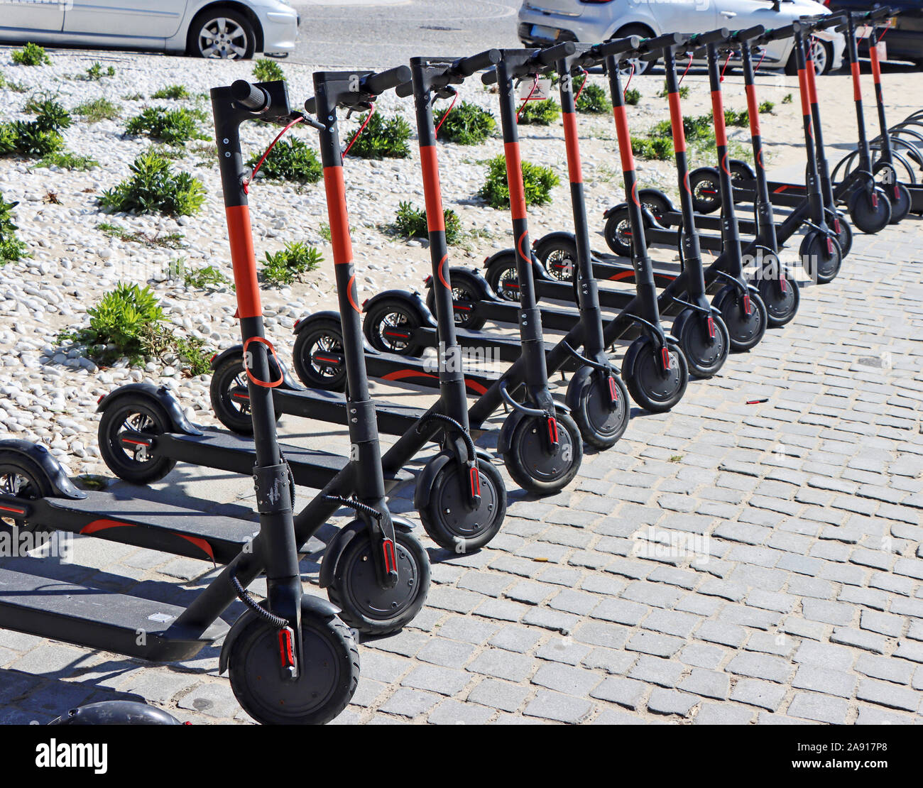 Electric kick scooter parked on rental station Stock Photo