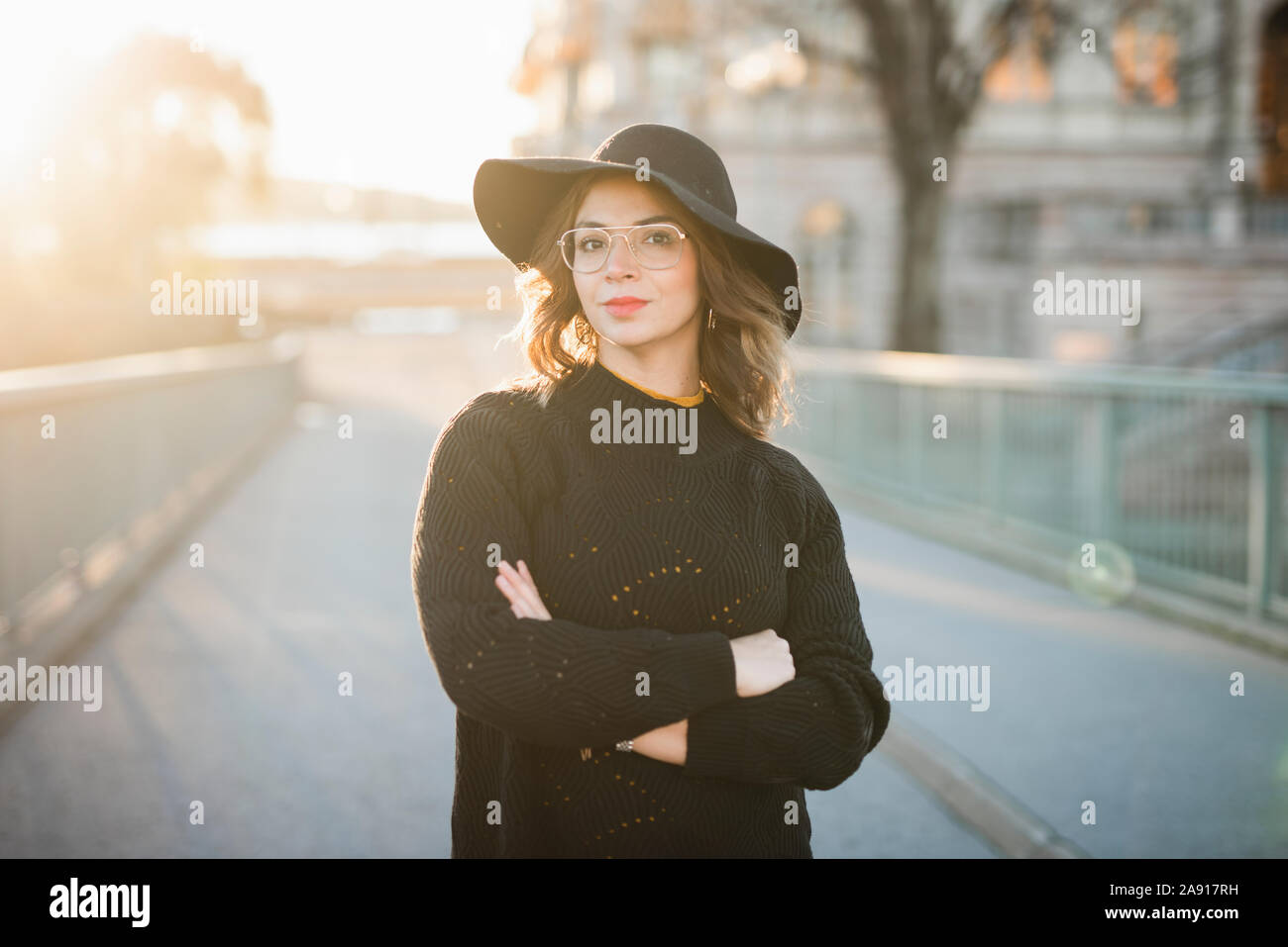 Woman in hat standing crossed hi-res stock photography and images - Alamy