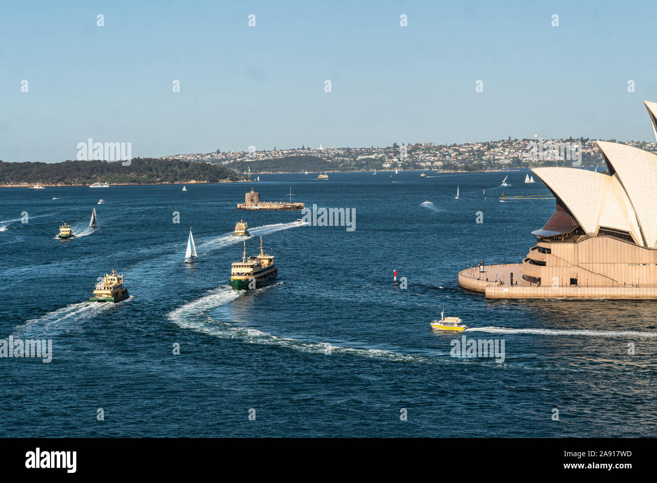 Sydney, Australia - October 3 2019: Various ferry boats sail around the Sydney harbor with the famous Opera House and the fort Denison in Australia la Stock Photo