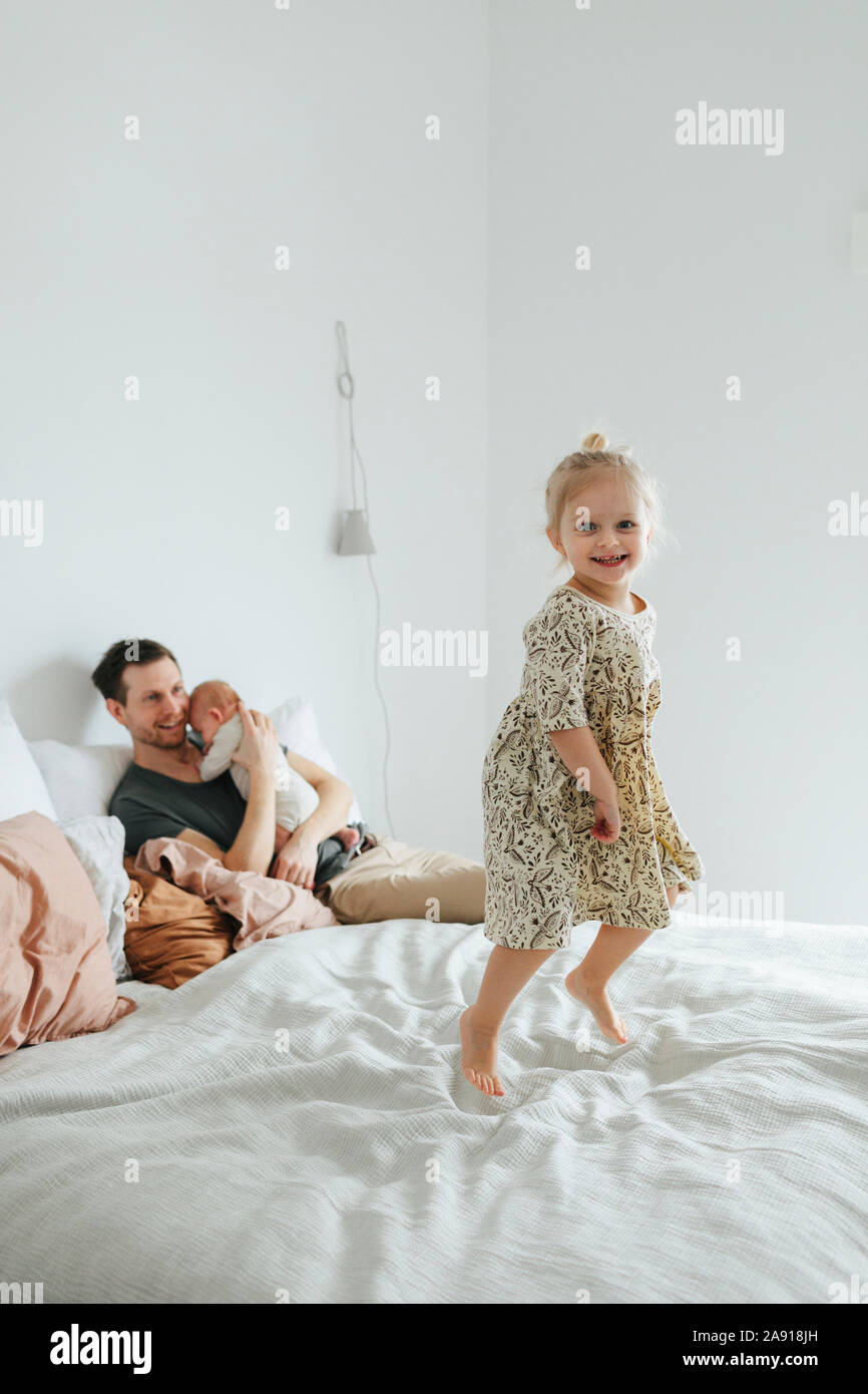 Girl jumping on bed Stock Photo