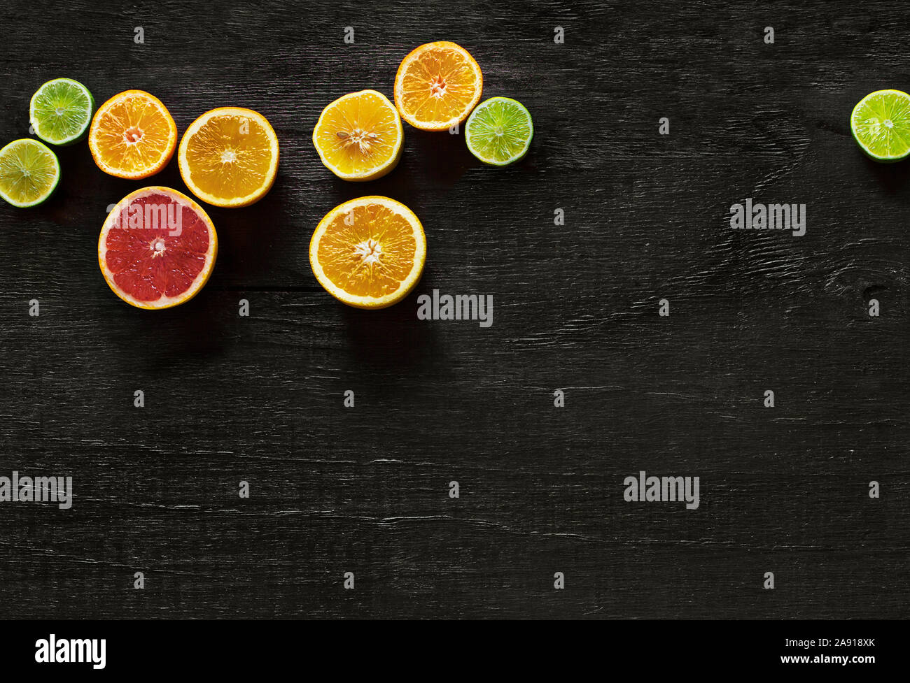 Citrus fruits on black background Stock Photo - Alamy