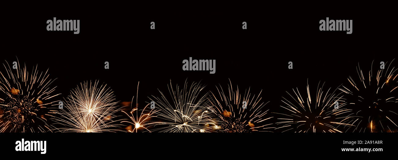 Golden fireworks panoramic background with copyspace, new year and holiday night party web banner Stock Photo