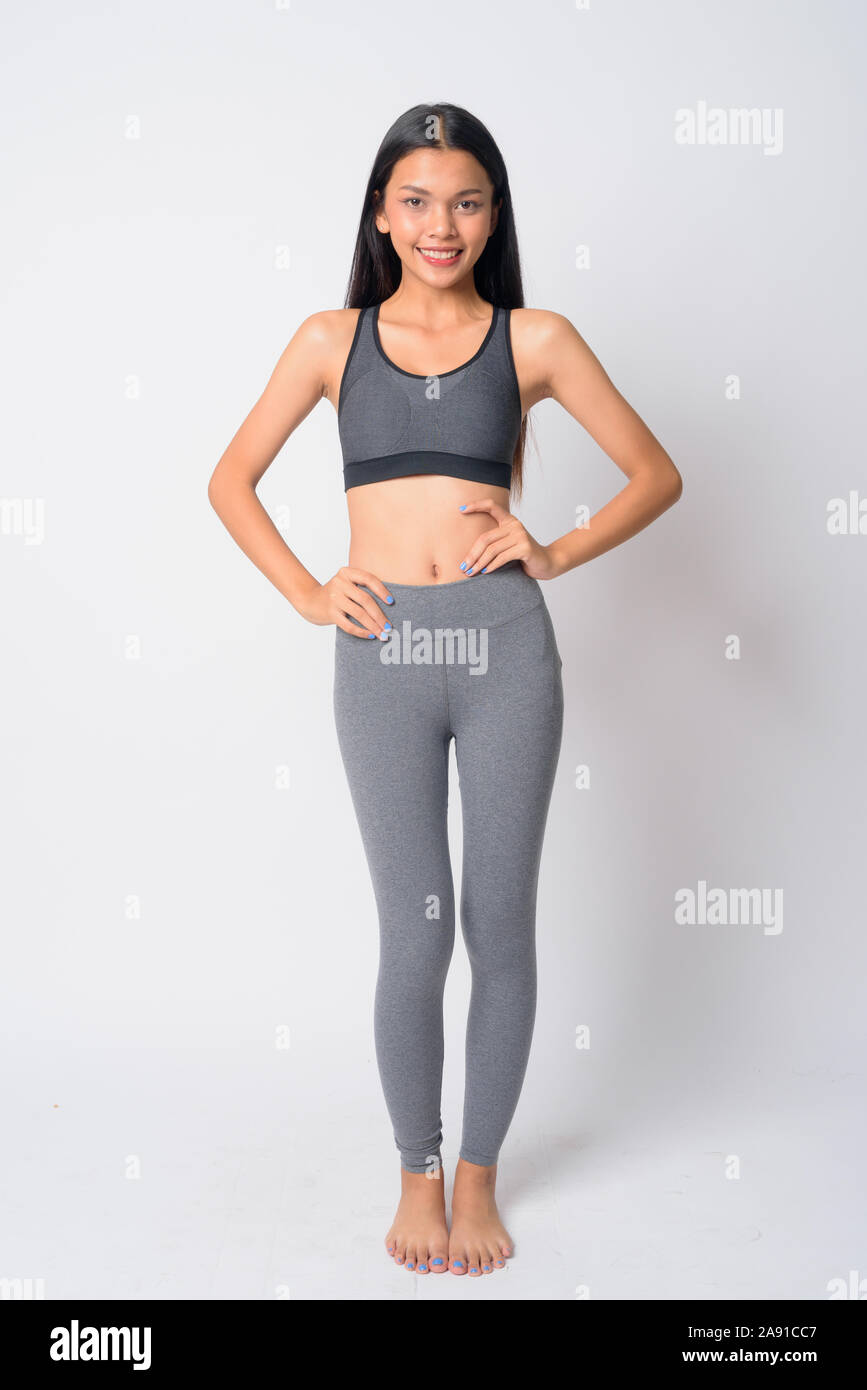 Full body shot of happy young Asian woman smiling ready for gym Stock ...