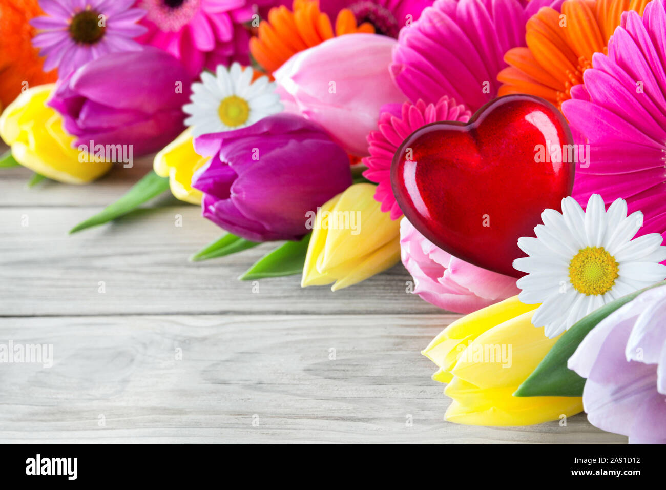 Bouquet of various flowers and red heart Stock Photo - Alamy