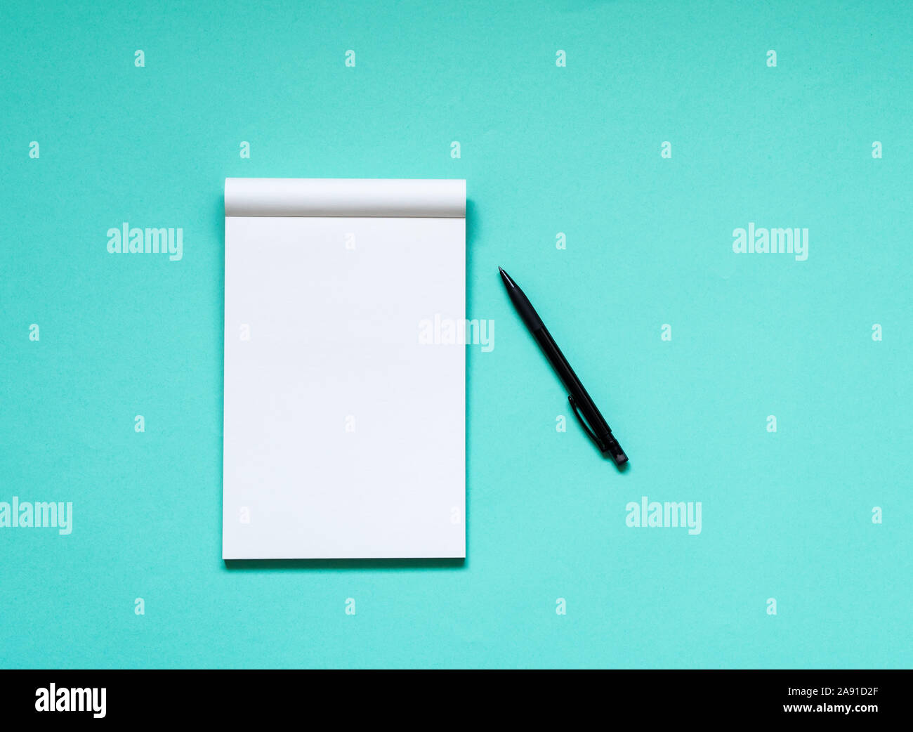 Top view workspace mockup on aqua background with open notebook and pen Stock Photo