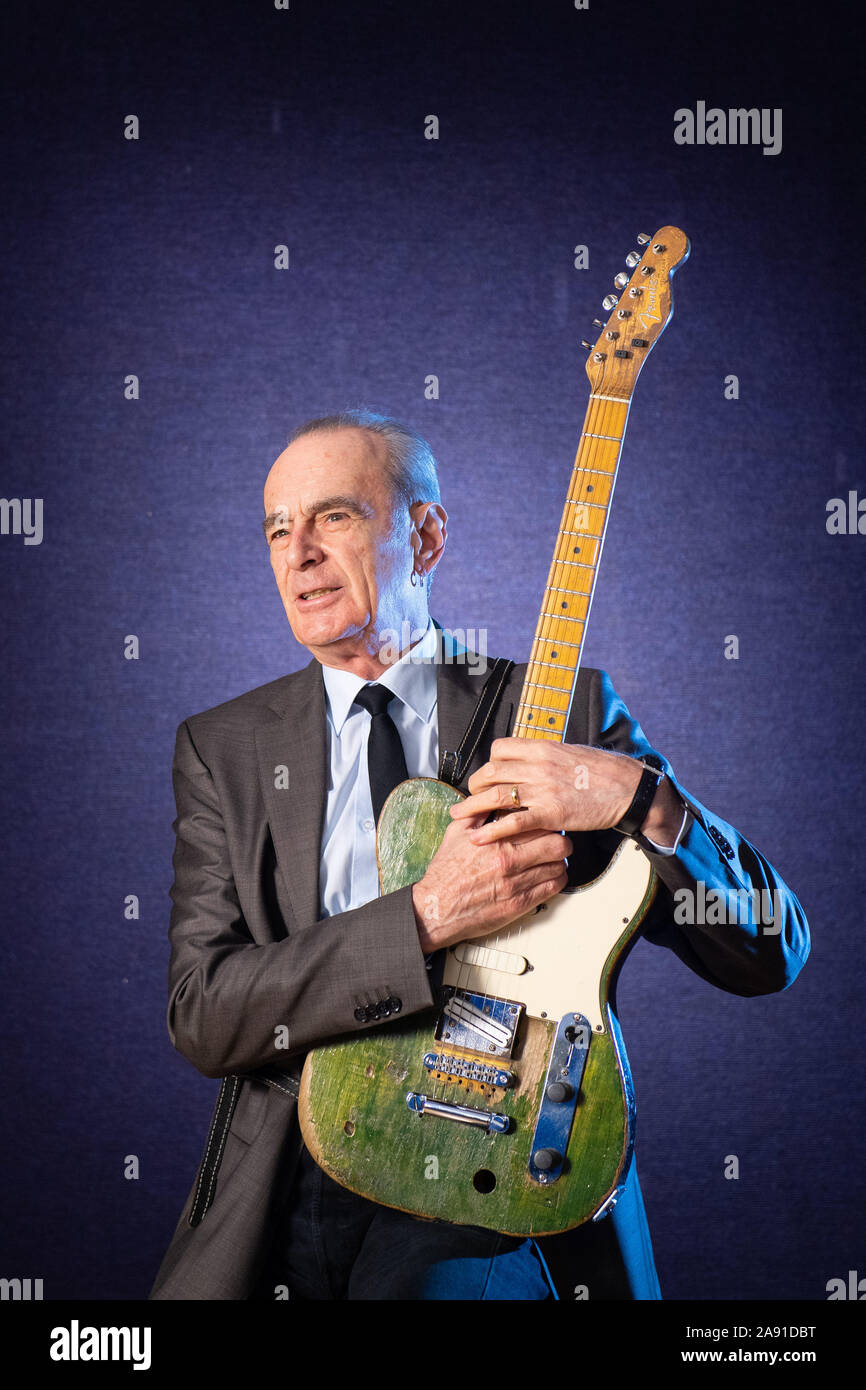 Francis Rossi of Status Quo poses with his green Fender Telecaster guitar  during a photocall at Bonham's auction house, London. Rossi's guitar is  estimated to fetch £100,000 to £150,000 as part of