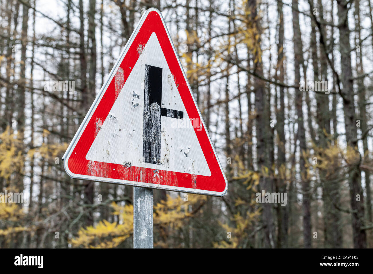 Grungy road sign. Adjoining a secondary road Stock Photo