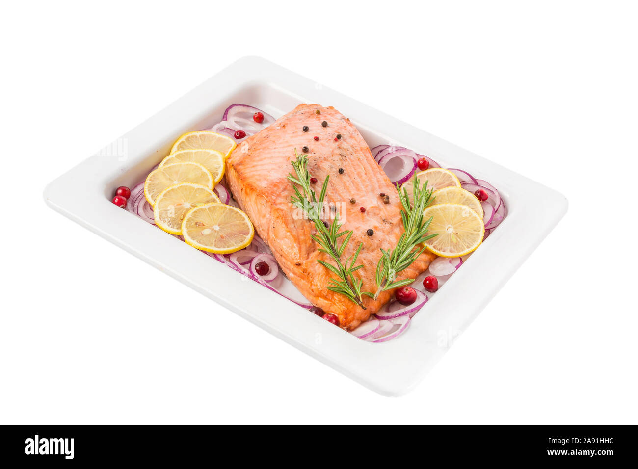 Salmon fillet with rosemary, onion and lemon in a plate isolated on white background. close up. healthy diet food Stock Photo