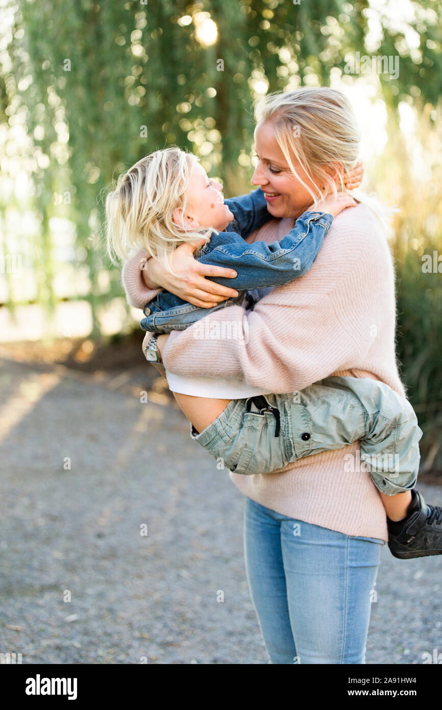 Mother hugging son Stock Photo