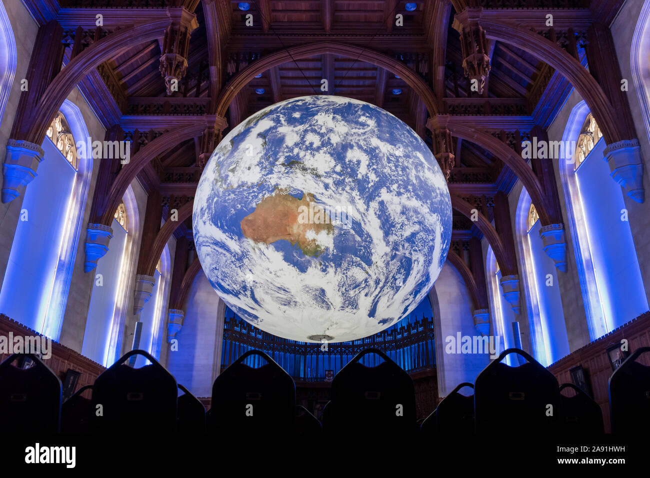 Luke Jerram's Gaia, suspended from the ceiling of the Great Hall in the Wills Memorial Building at the University of Bristol. Stock Photo