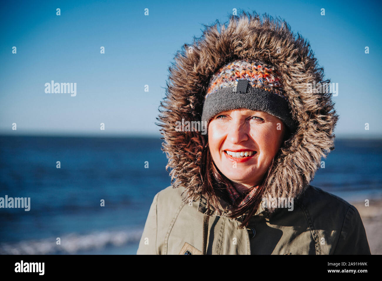 Smiling woman at sea Stock Photo