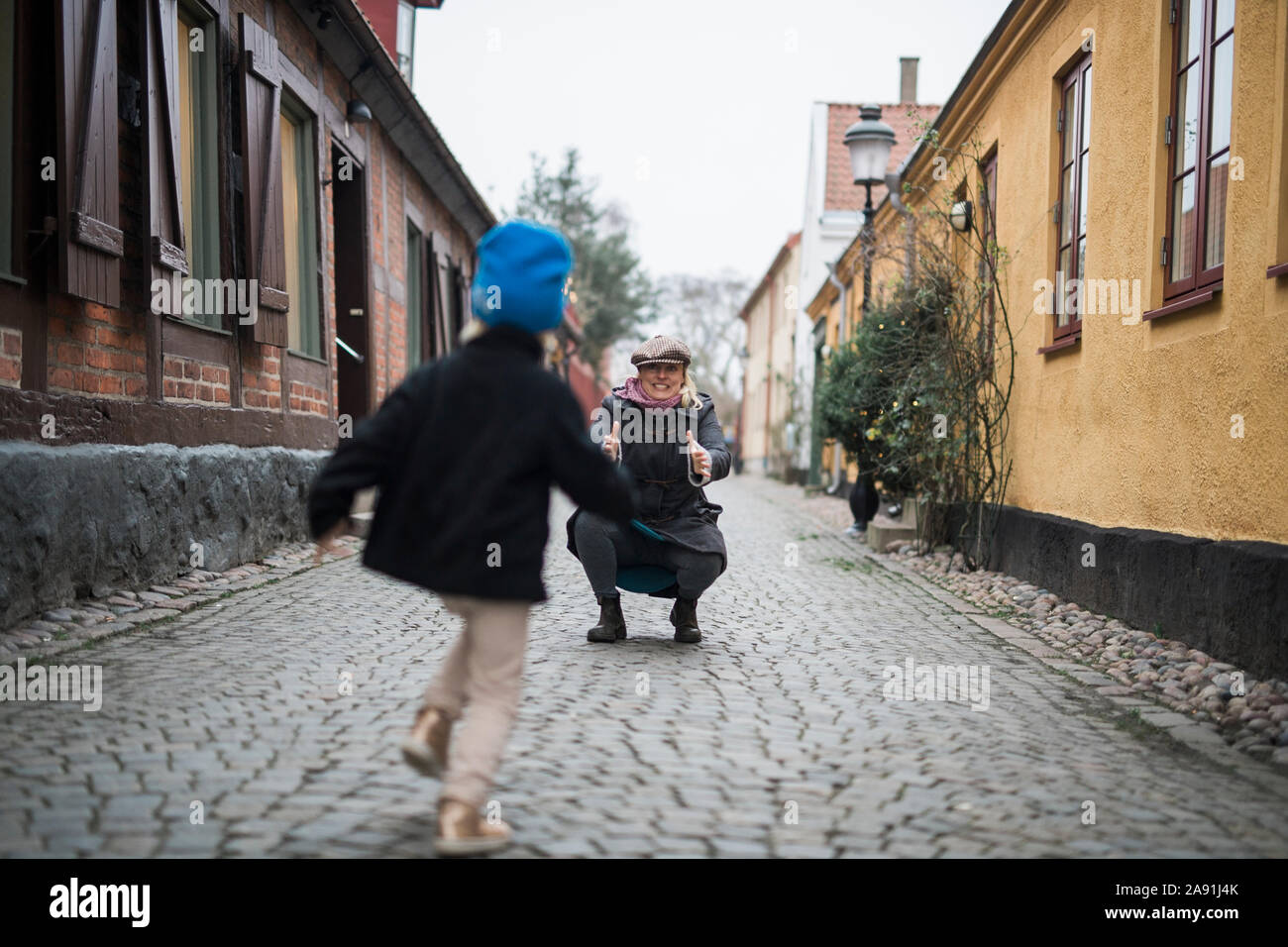 Father with daughter on cobblestone street Stock Photo