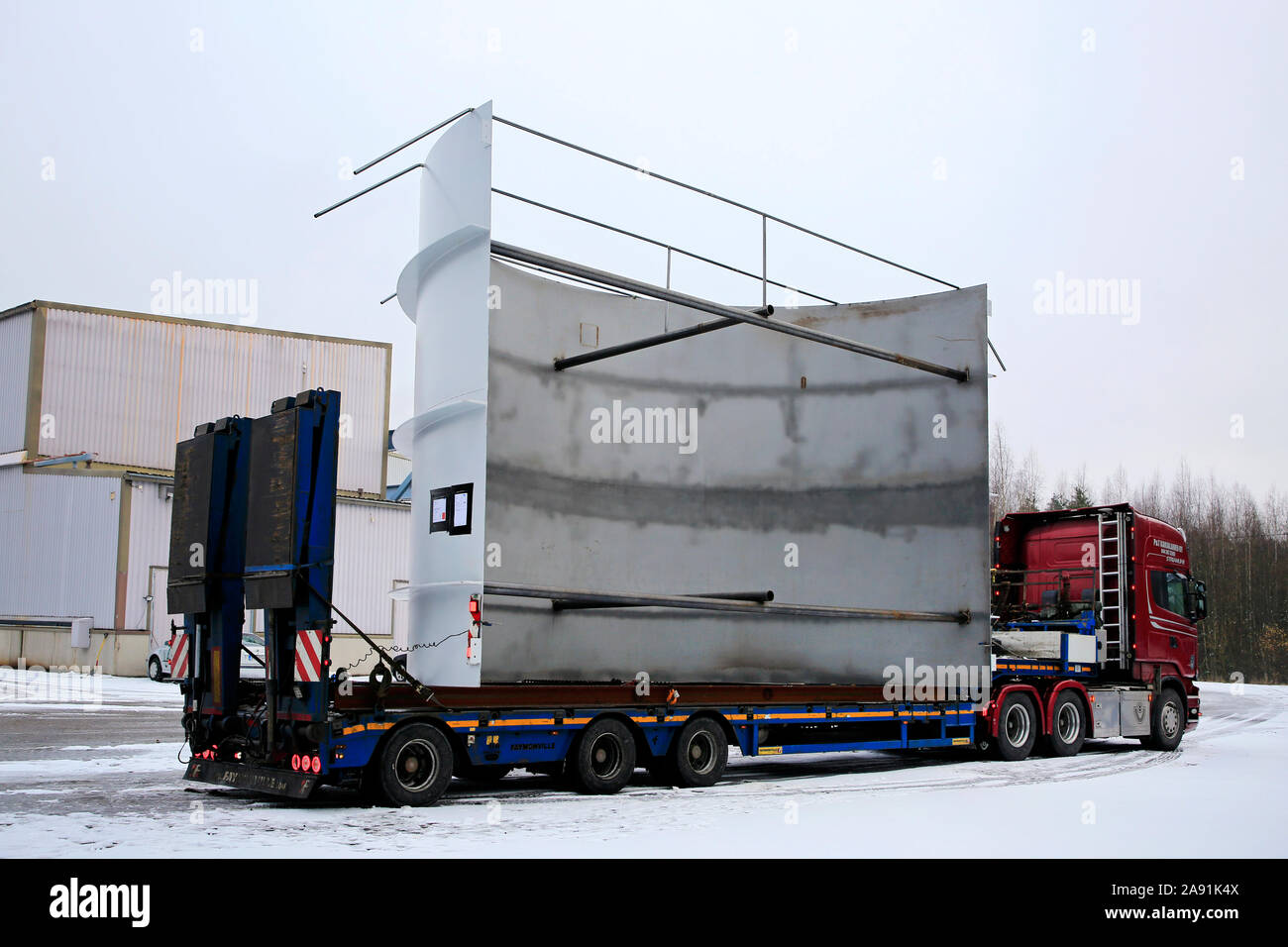 Semi trailer carrying a steel frame on loading area of the factory. Halikko manufactured diamondback chip bin ships to Chile. Salo, Finland. Nov 8, 19 Stock Photo