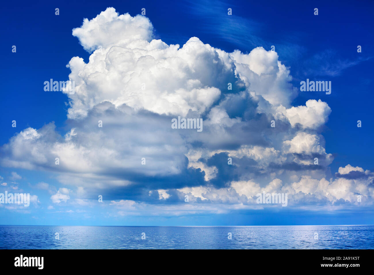 White cumulus clouds over sea close up blue sky background landscape, big fluffy cloud above ocean water panorama, cloudy weather seascape, cloudscape Stock Photo