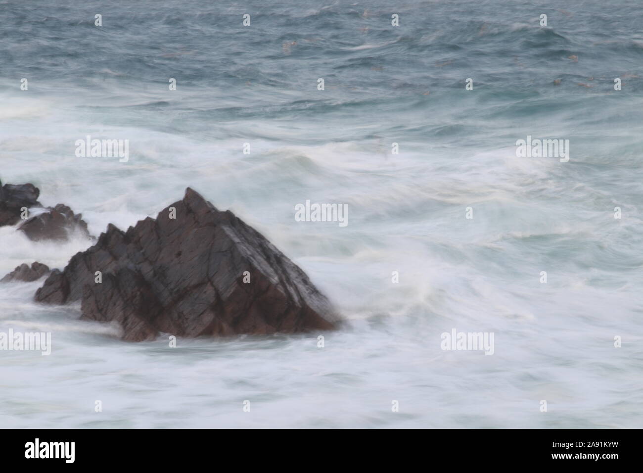 Rock and waves Stock Photo - Alamy