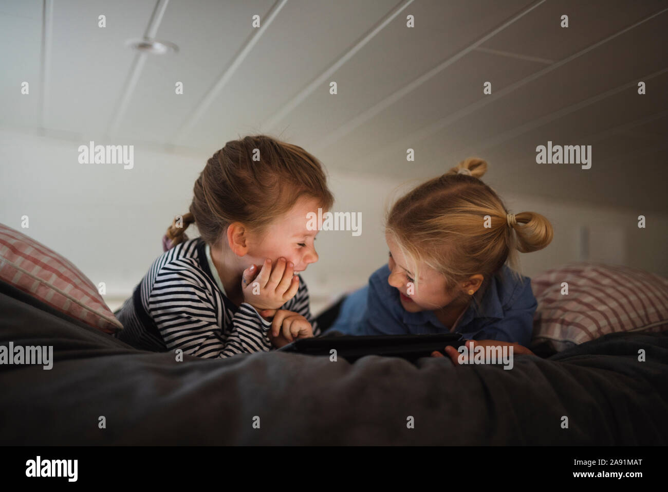 Sisters using digital tablet Stock Photo