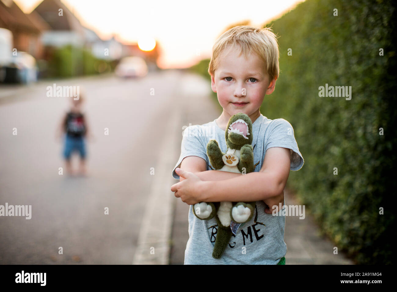 Boy holding stuffed dinosaur Stock Photo