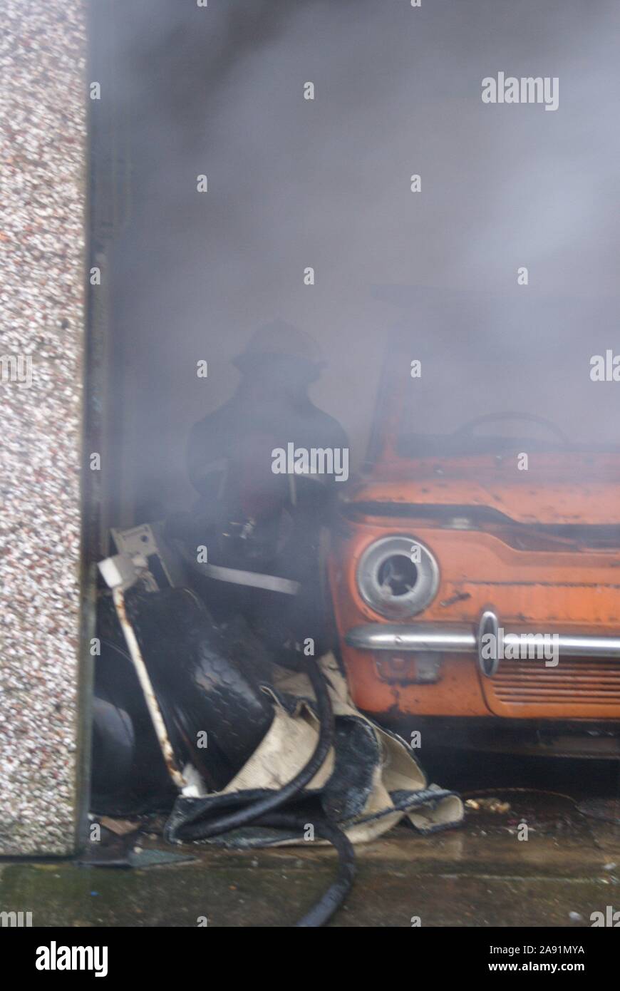 Car on fire in garage Stock Photo Alamy
