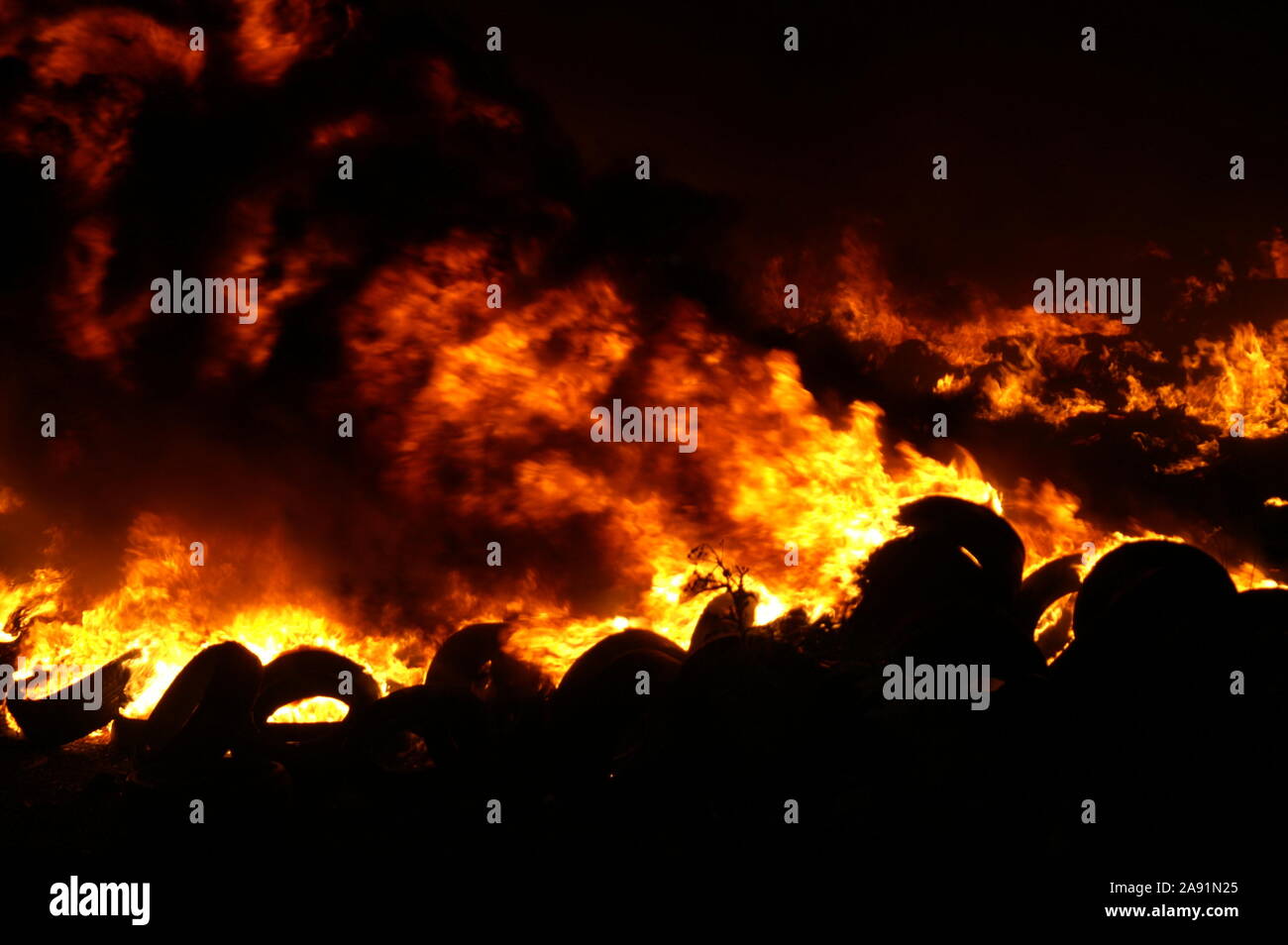 used car tyres storage site on fire, Industrial waste, arson Stock Photo