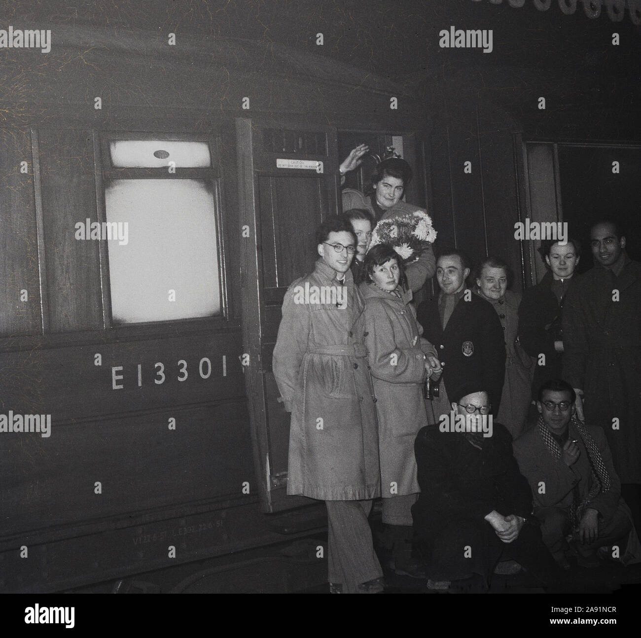 1950s, historical, group of people on a train platform, including those ...