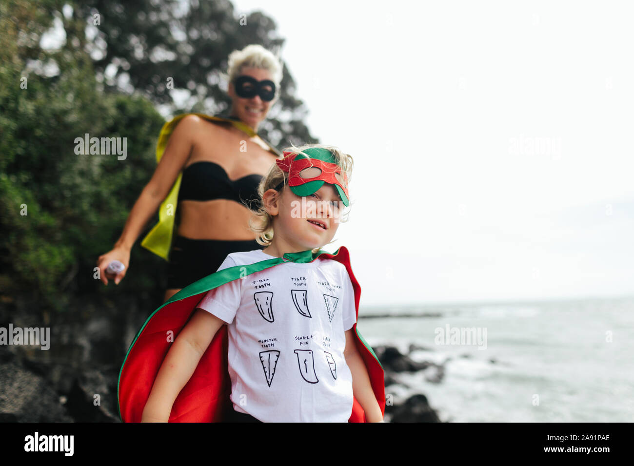 Mother and son wearing superhero costumes Stock Photo