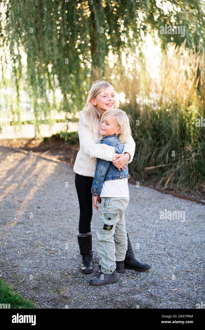 Brother and sister hugging Stock Photo