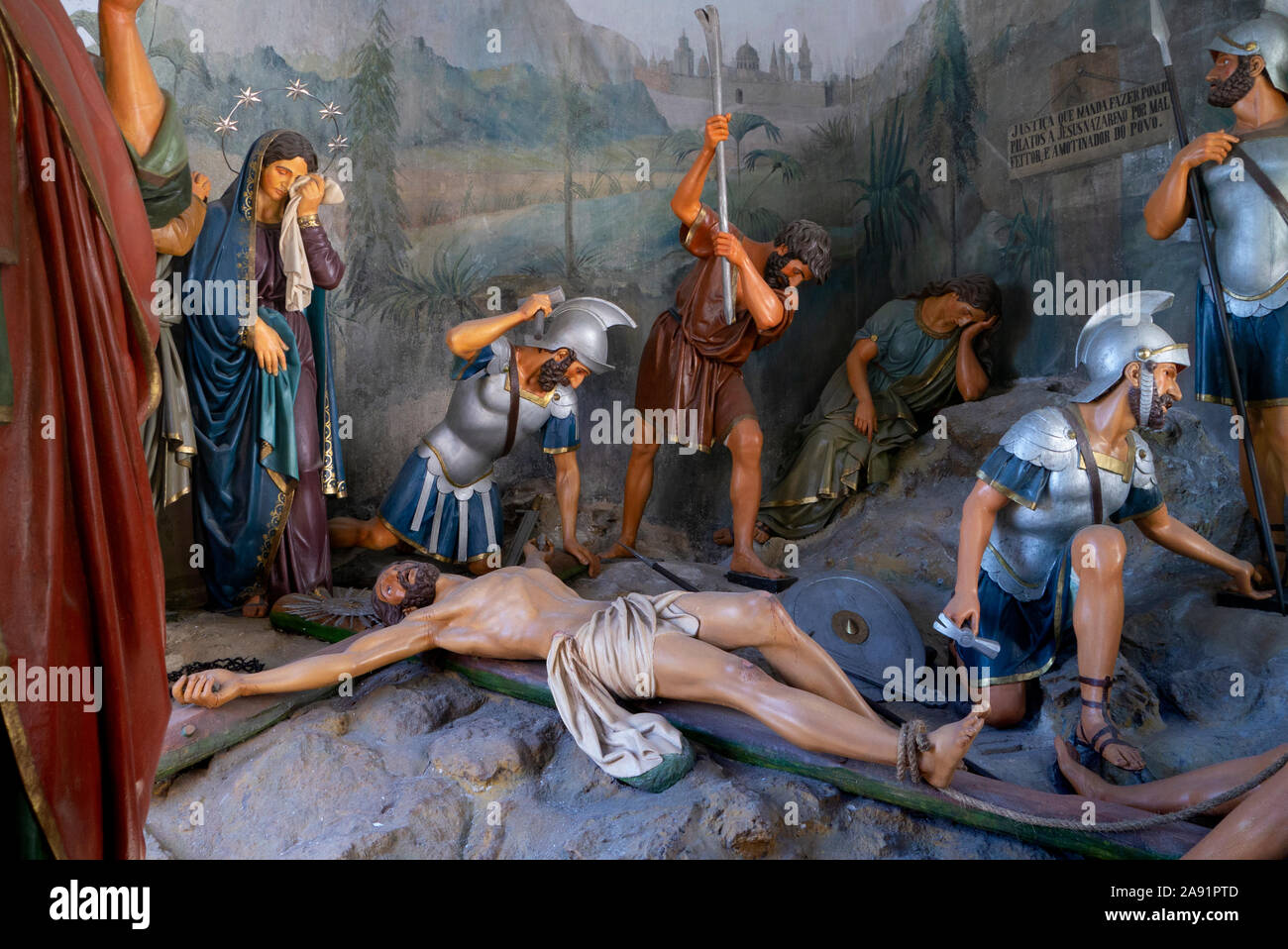 One of the Stations of the Cross depicting with statues Jesus being put on the cross at the Bom Jesus complex in Braga Portugal Stock Photo