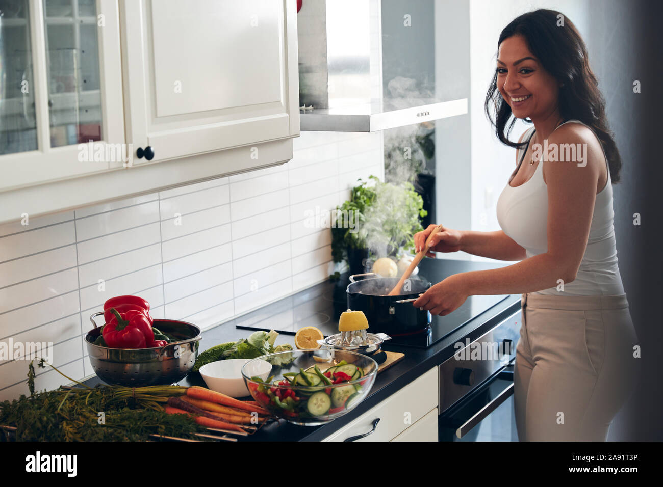 Woman preparing healthy food in kitchen Stock Photo