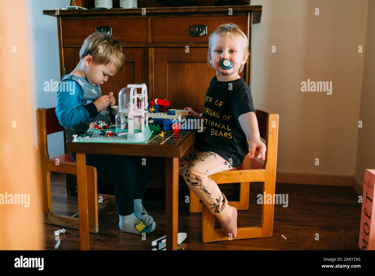 Brothers playing with Lego Stock Photo