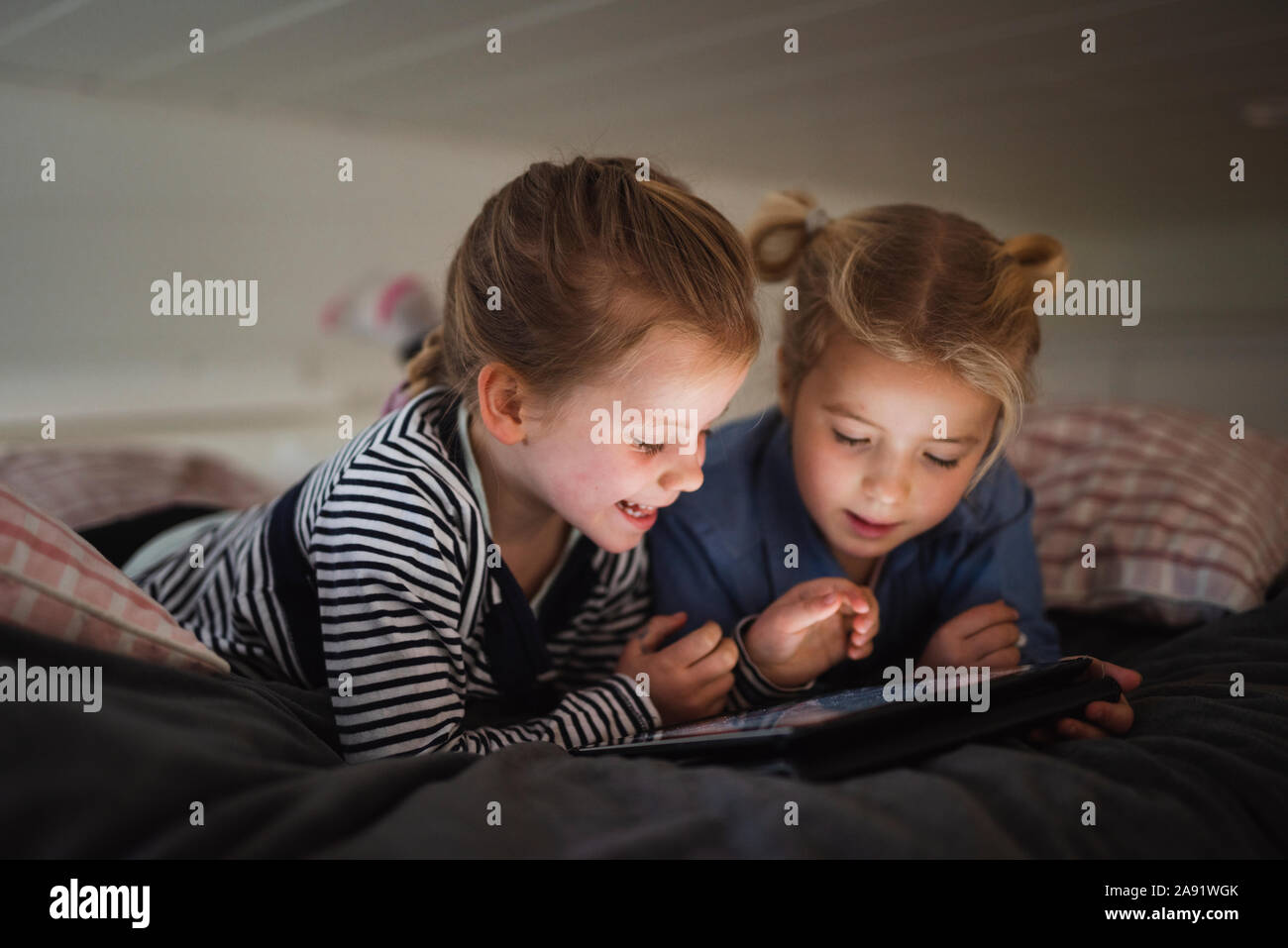 Sisters using digital tablet Stock Photo