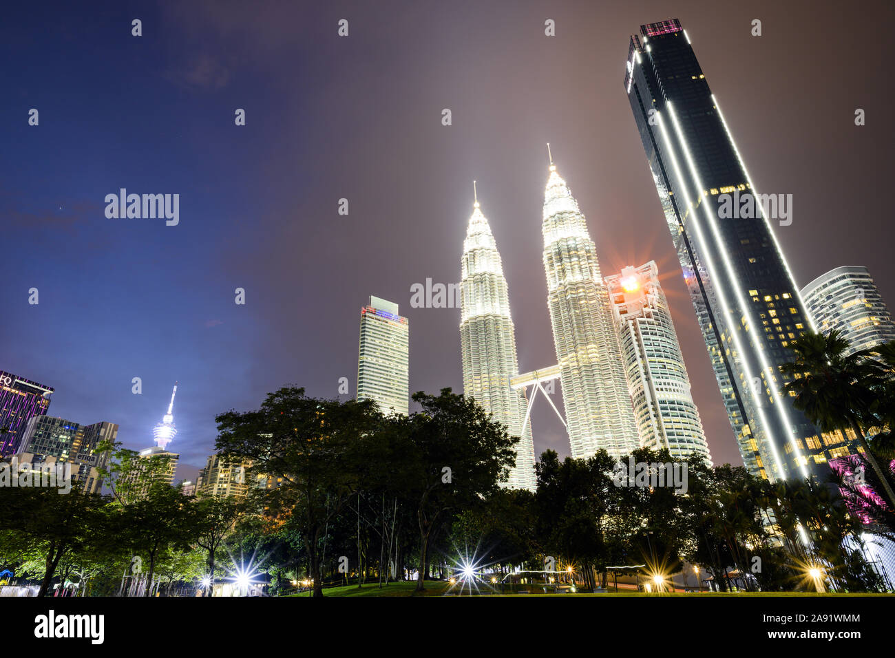Stunning view of the Petronas Twin Tower illuminated at dusk. The Petronas Towers are twin skyscrapers in Kuala Lumpur. Stock Photo