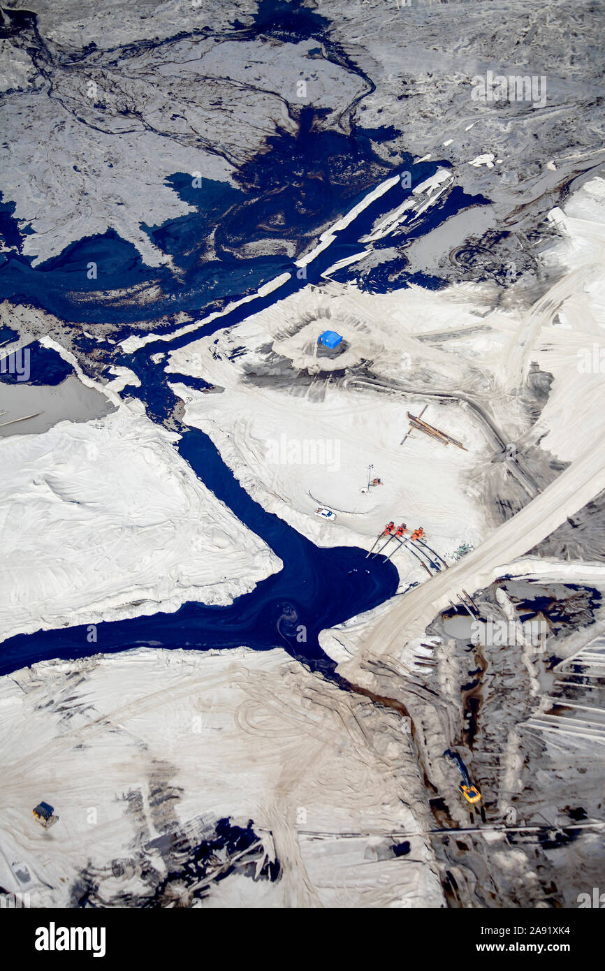 Detail from one of the enormous tailings ponds in Fort McMurray in Alberta, Canada. The ponds are among the largest man made structures in the world, spanning more than 175 square kilometres. They pose an added challenge to the oil sands production: even after ended production, it can take up to 30 years for the silt in the ponds to dry up. The contaminated water is toxic to any living creatures. The Athabasca oil sands deposit is among the largest in the world.  The bitumen, also commonly named tar (hence tar sands), contains lots of hydrocarbons, but is notoriously hard to extract. For every Stock Photo