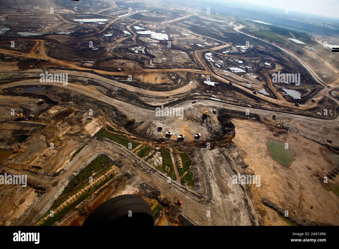 Excavation of oil sand at one of the oil sand mines in Fort McMurray in ...