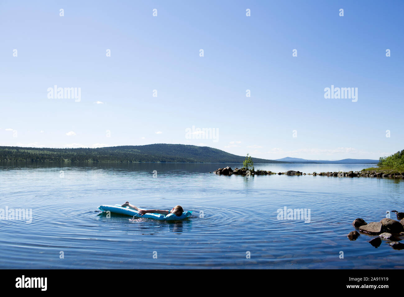 Boy on inflatable raft Stock Photo