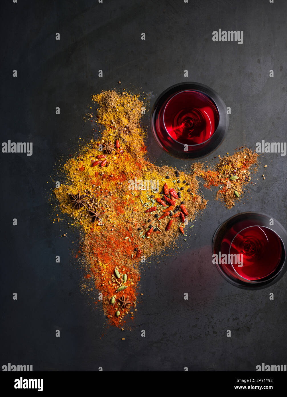 Spices and wineglasses on grey background Stock Photo
