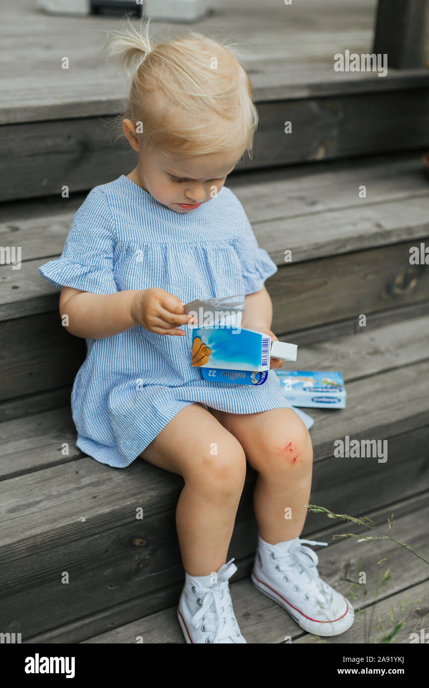 Girl with scratched knee Stock Photo