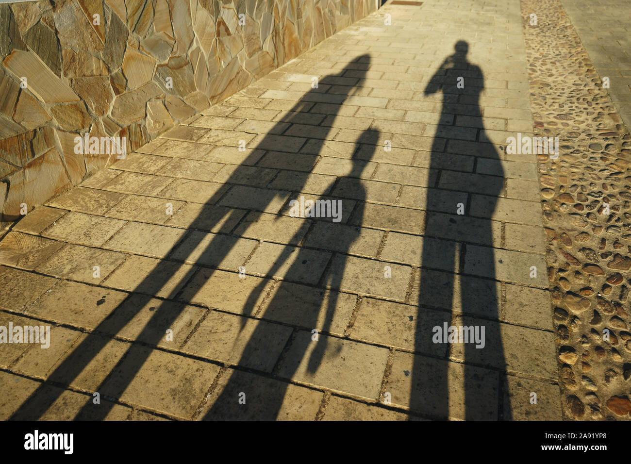 Shadow of people (family) on ground Stock Photo - Alamy