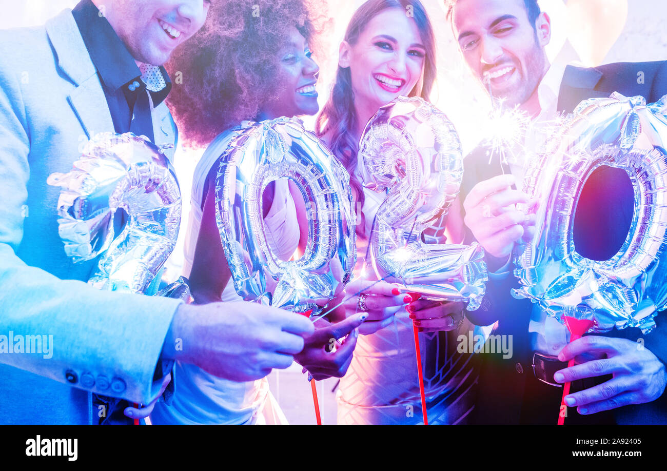 Men and women celebrating the new year 2020 Stock Photo