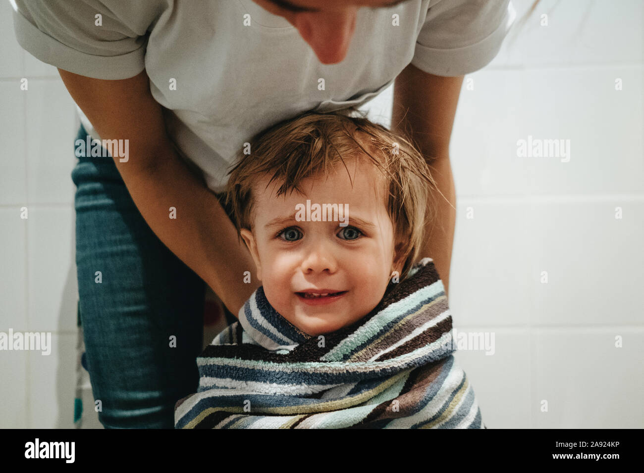 Toddler girl wrapped in blanket Stock Photo