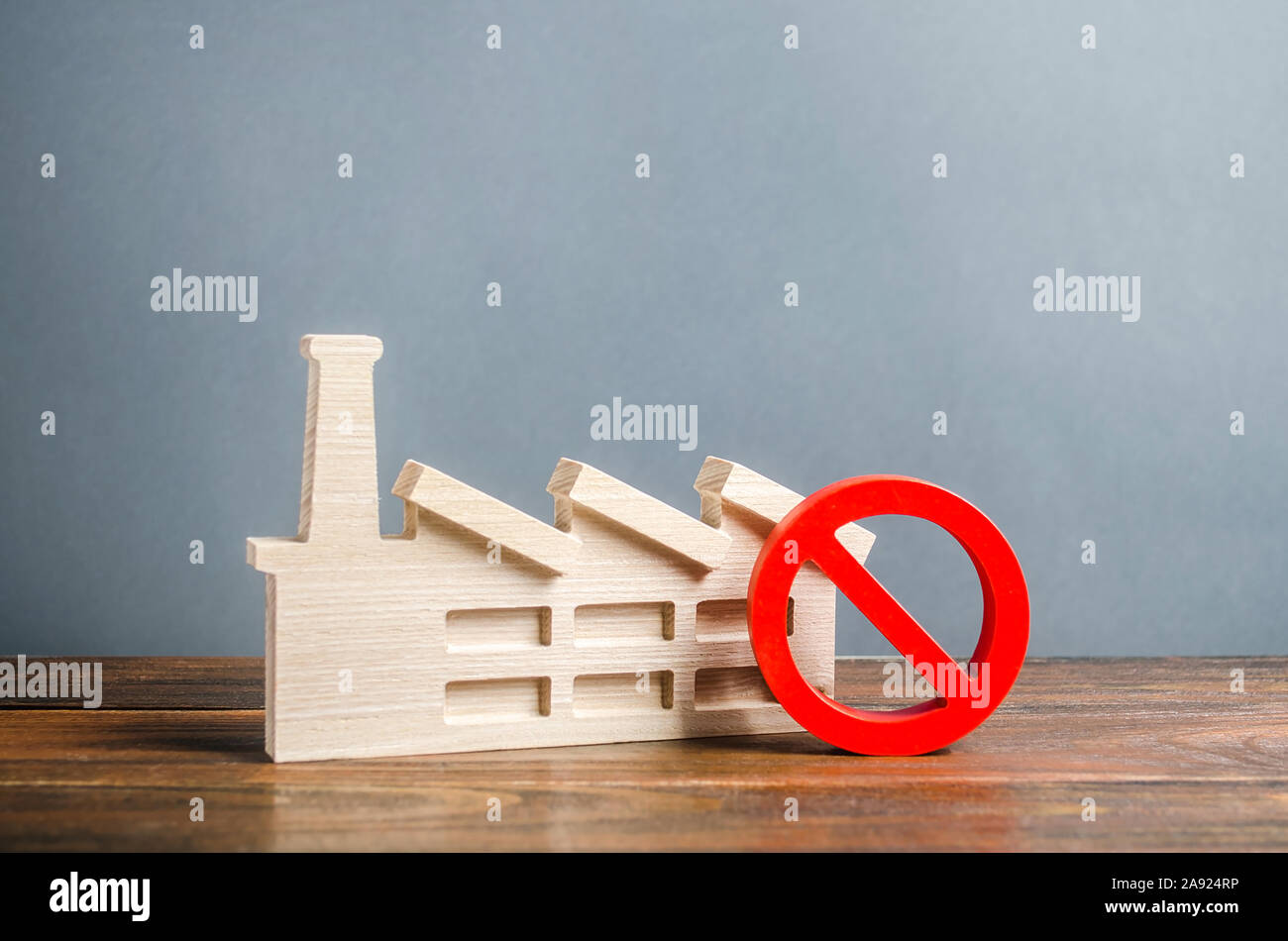 Factory figurine and red prohibition symbol NO. Restrictions and prohibitions of the functioning of industrial enterprises. facilities. Close harmful Stock Photo