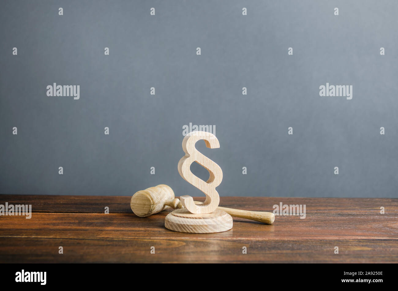Paragraph figurine and judge's gavel. Justice and judicial system concept. Legal assistance, services of lawyers. Democratic institutions, human right Stock Photo