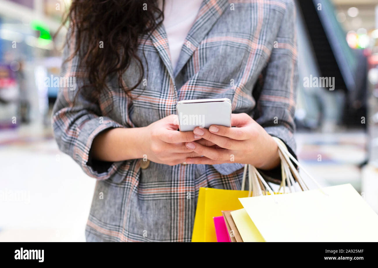 Mobile app with discount. Woman using cellphone Stock Photo