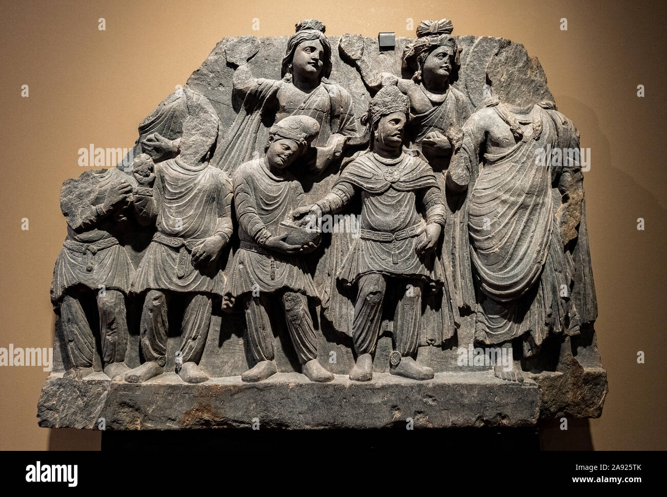 Italy Piedmont Turin - Mazzonis Palace - Mao Museum ( Museo d'Arte Orientale ) - Museum of Oriental art - Homage of a Kushan King to a Bodhisattva  - A king in central Asian dress makes on a offering to a bodhisattva - Gandhara 2nd-3rd century A.D. Stock Photo
