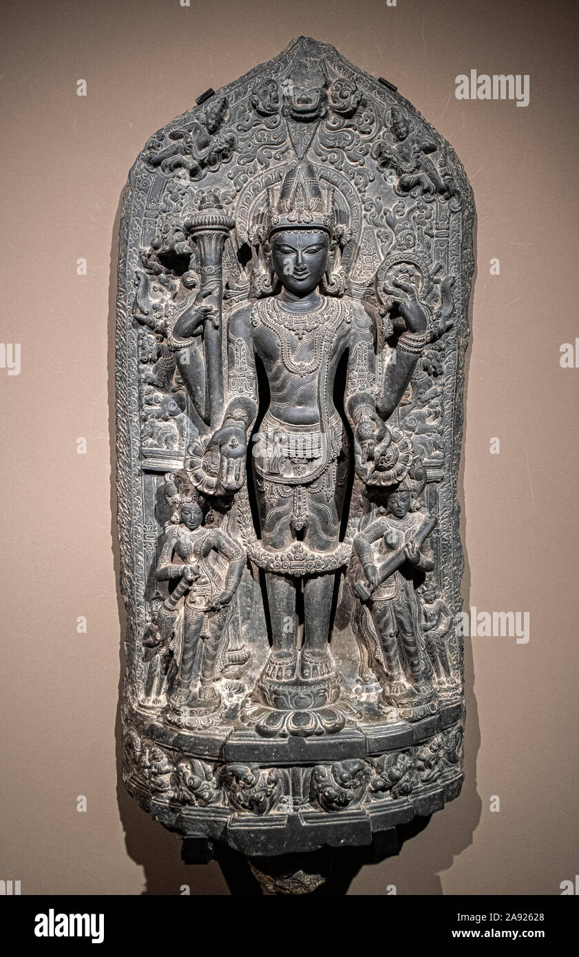 Italy Piedmont Turin - Mazzonis Palace - Mao Museum ( Museo d'Arte Orientale ) - Museum of Oriental art -  Vishnu - The God Vishnu with Lakshmi, Goddes of Fortune and riches on his right , and Sarasvati, goddess of speech and knowledge on his left - Nortth East india  12th century A.D. Stock Photo