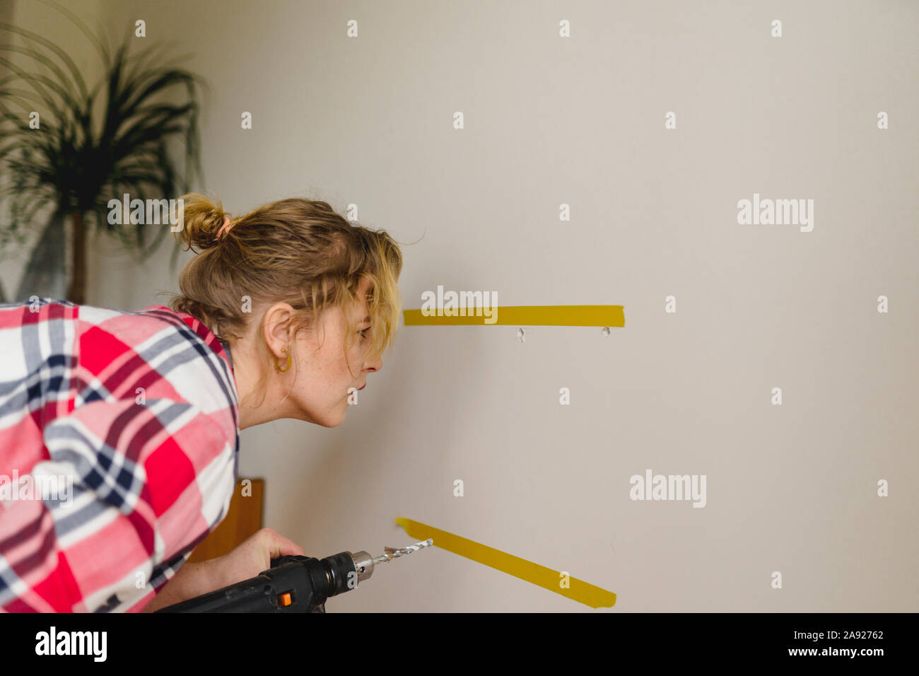 Woman with electric drill Stock Photo