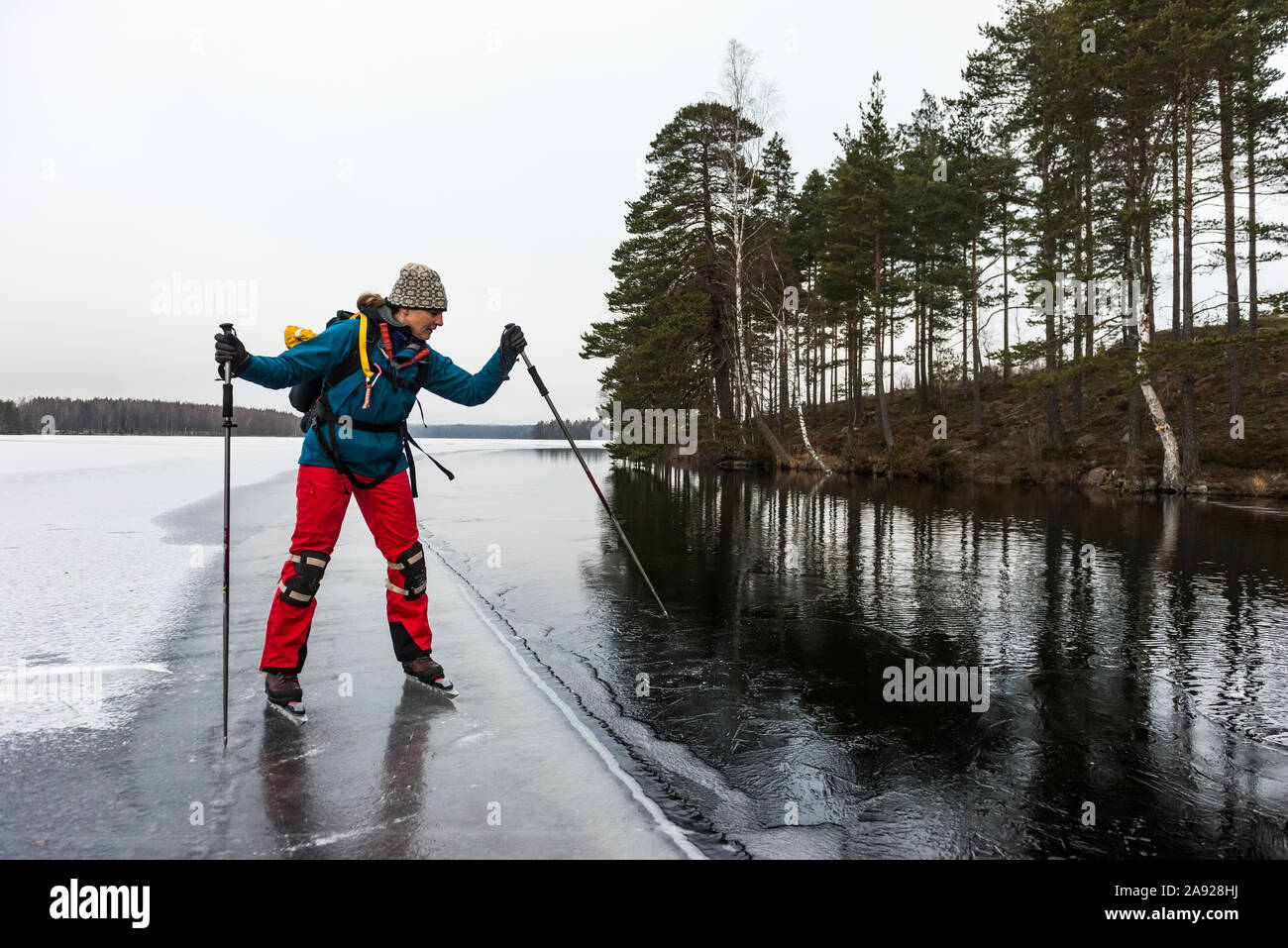 Ice skater on frozen lake Stock Photo - Alamy