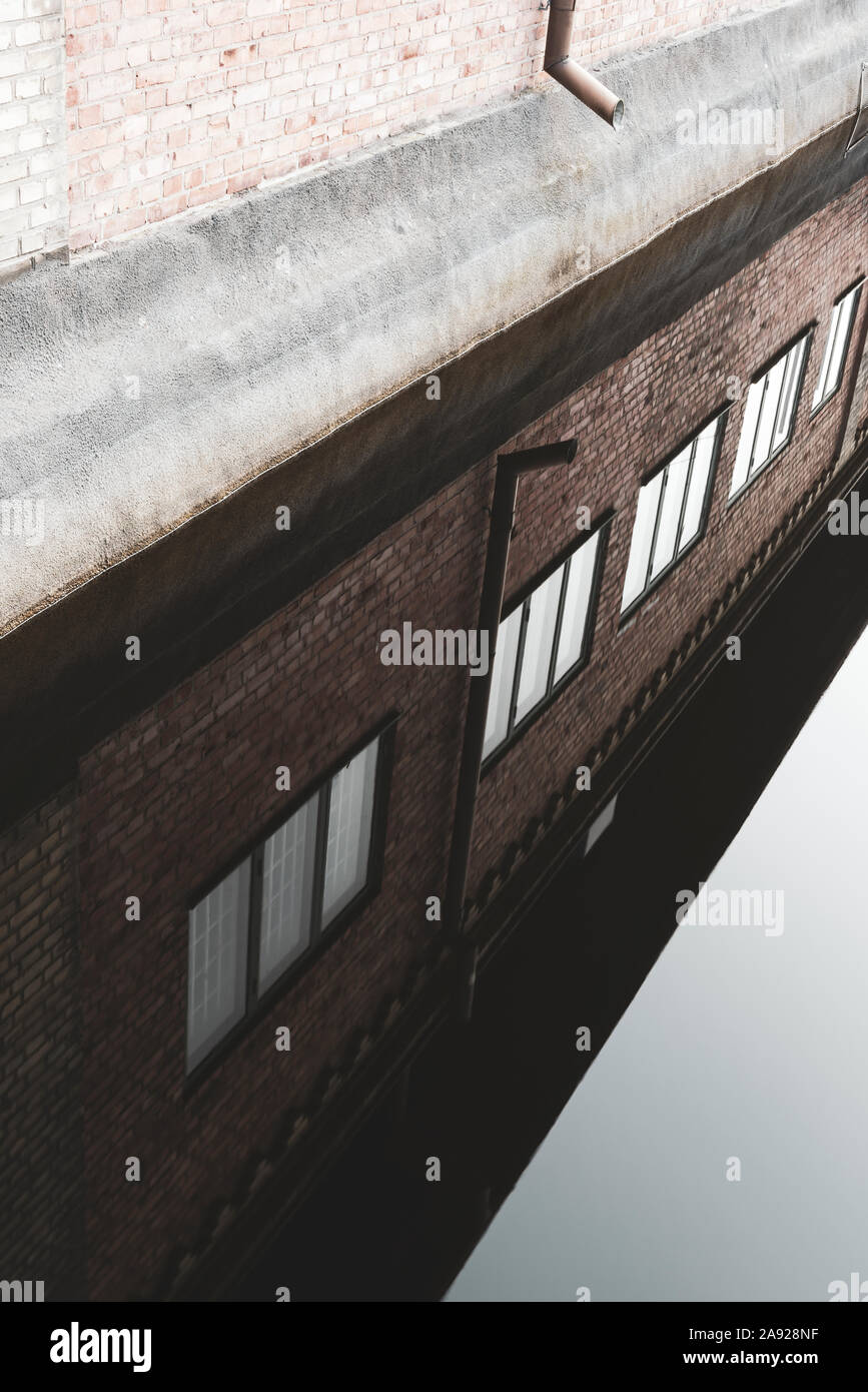 Brick building reflecting in water Stock Photo