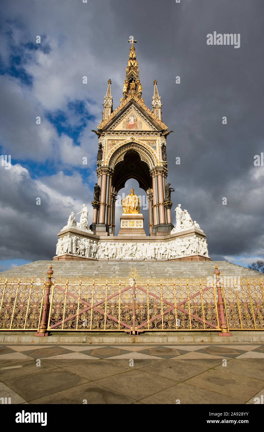 Albert Memorial, Kensington Gardens, London. The sun revealing the gold leaf texture contrasting against background storm clouds. Stock Photo